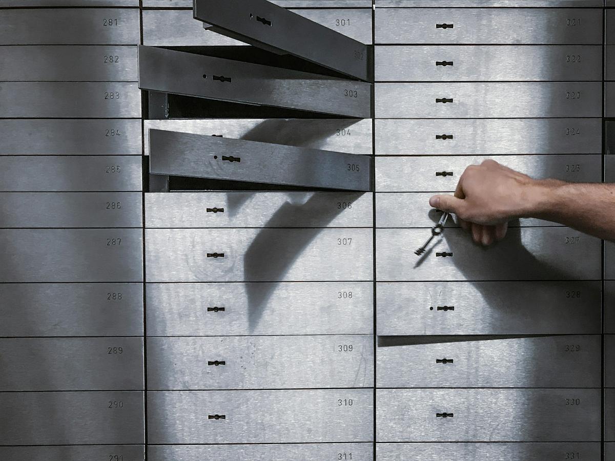 Hand unlocking a bank of secure key lockers