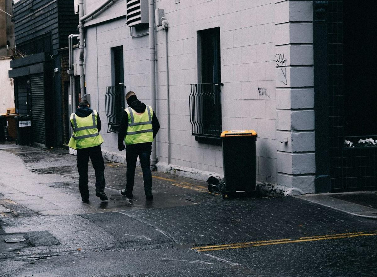 Two security officers in hi-vis vests on patrol